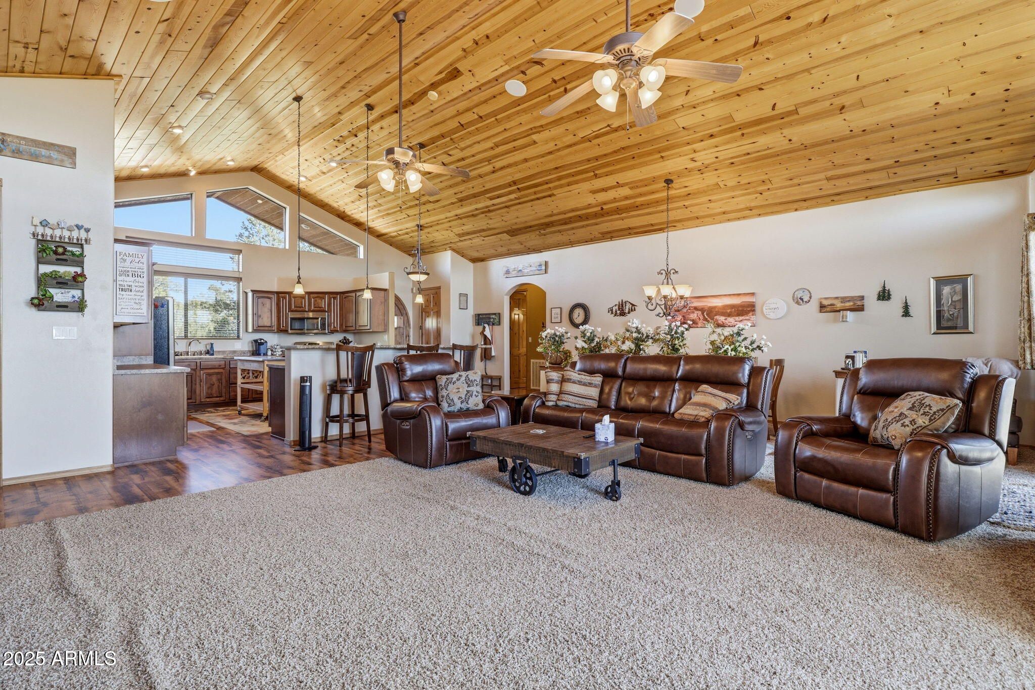 2276 Thunderbird Way Overgaard, AZ 85933 - Photo 15 of 41 a living room with lots of furniture and a chandelier