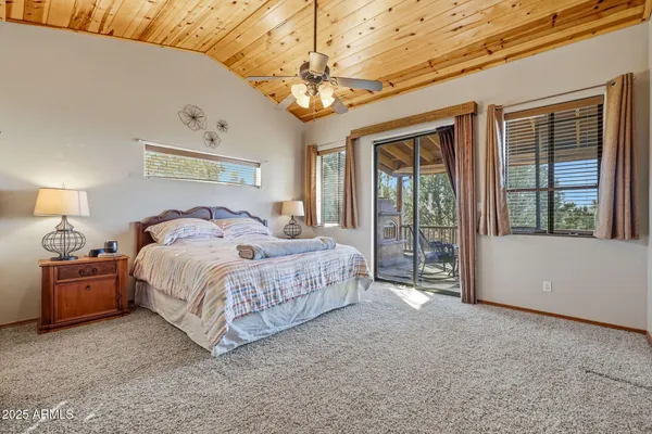 a spacious bedroom with a large bed and a chandelier