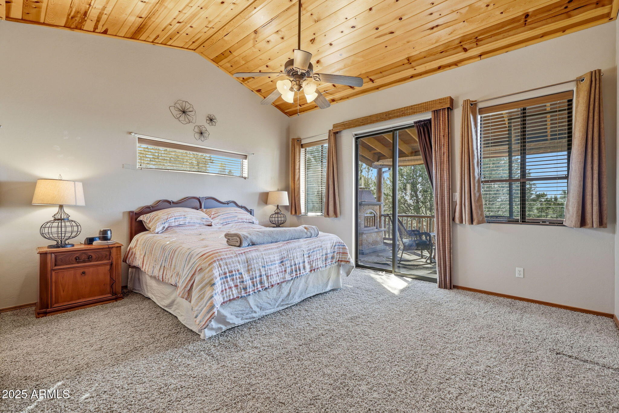 2276 Thunderbird Way Overgaard, AZ 85933 - Photo 20 of 41 a spacious bedroom with a large bed and a chandelier