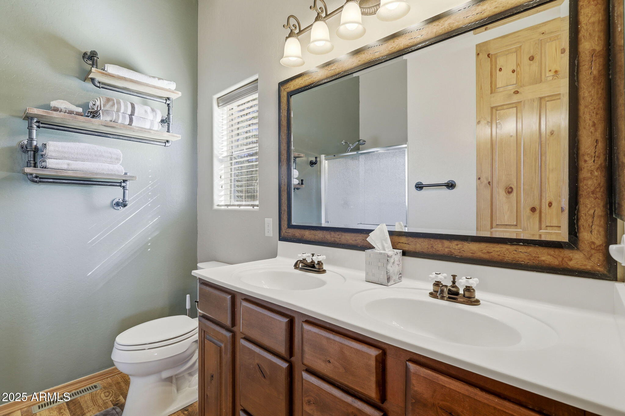 2276 Thunderbird Way Overgaard, AZ 85933 - Photo 24 of 41 a bathroom with a sink a toilet and mirror