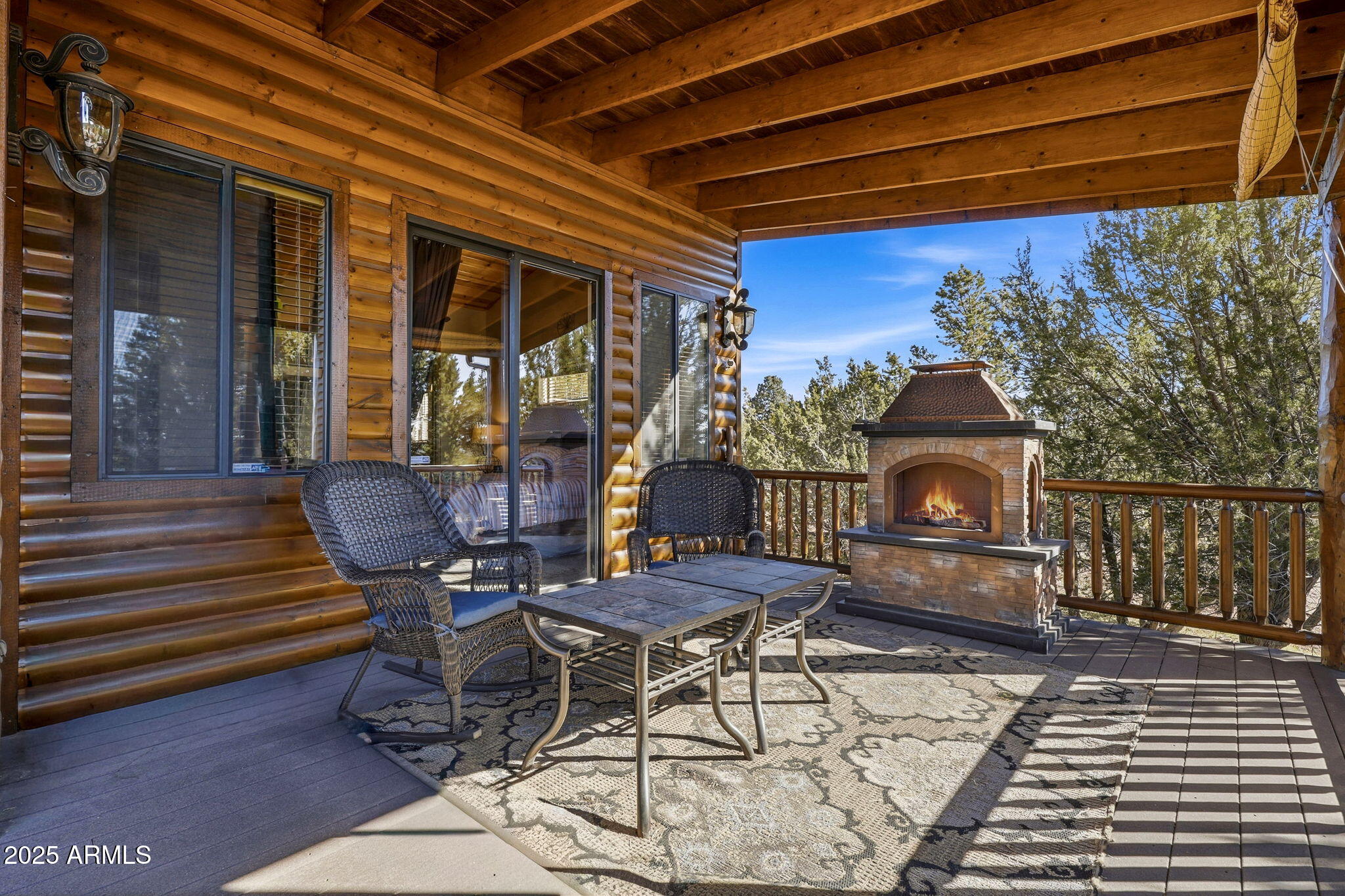 2276 Thunderbird Way Overgaard, AZ 85933 - Photo 3 of 41 a view of a patio with table and chairs with wooden floor and fence
