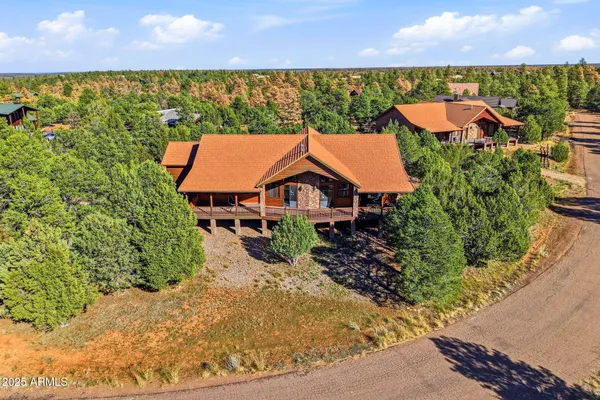 an aerial view of a house with swimming pool and garden