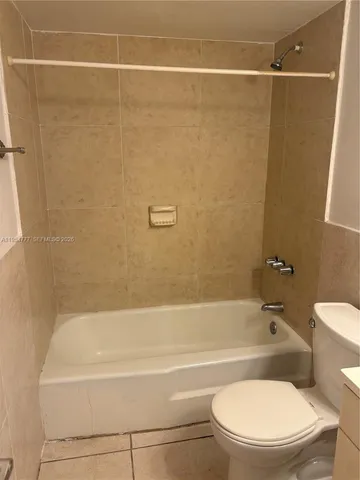 a bathroom with a toilet a sink and bathtub