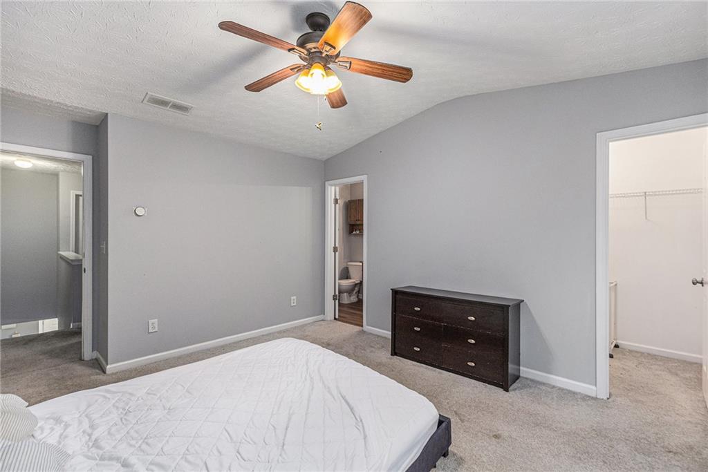 6536 Arbor Gate Drive Southwest, Unit 2 Mableton, GA 30126 - Photo 19 of 27 a bedroom with a bed and a ceiling fan