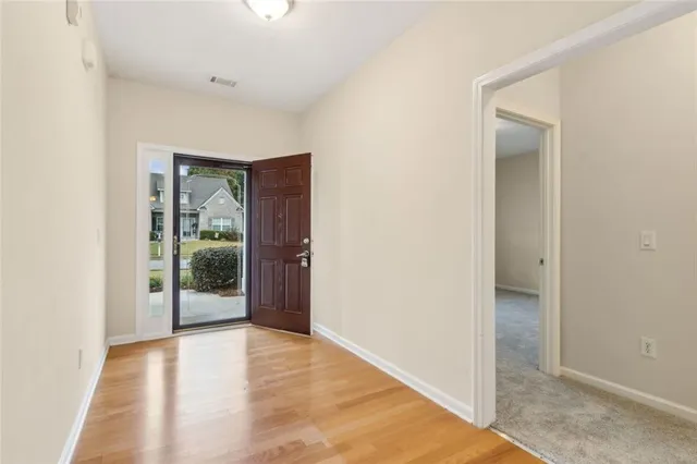 an empty room with sliding door and mirror