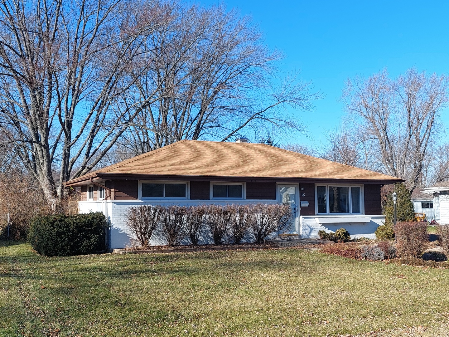 16 Aldine Road Lake Zurich, IL 60047 - Photo 2 of 24 a front view of a house with a garden and trees