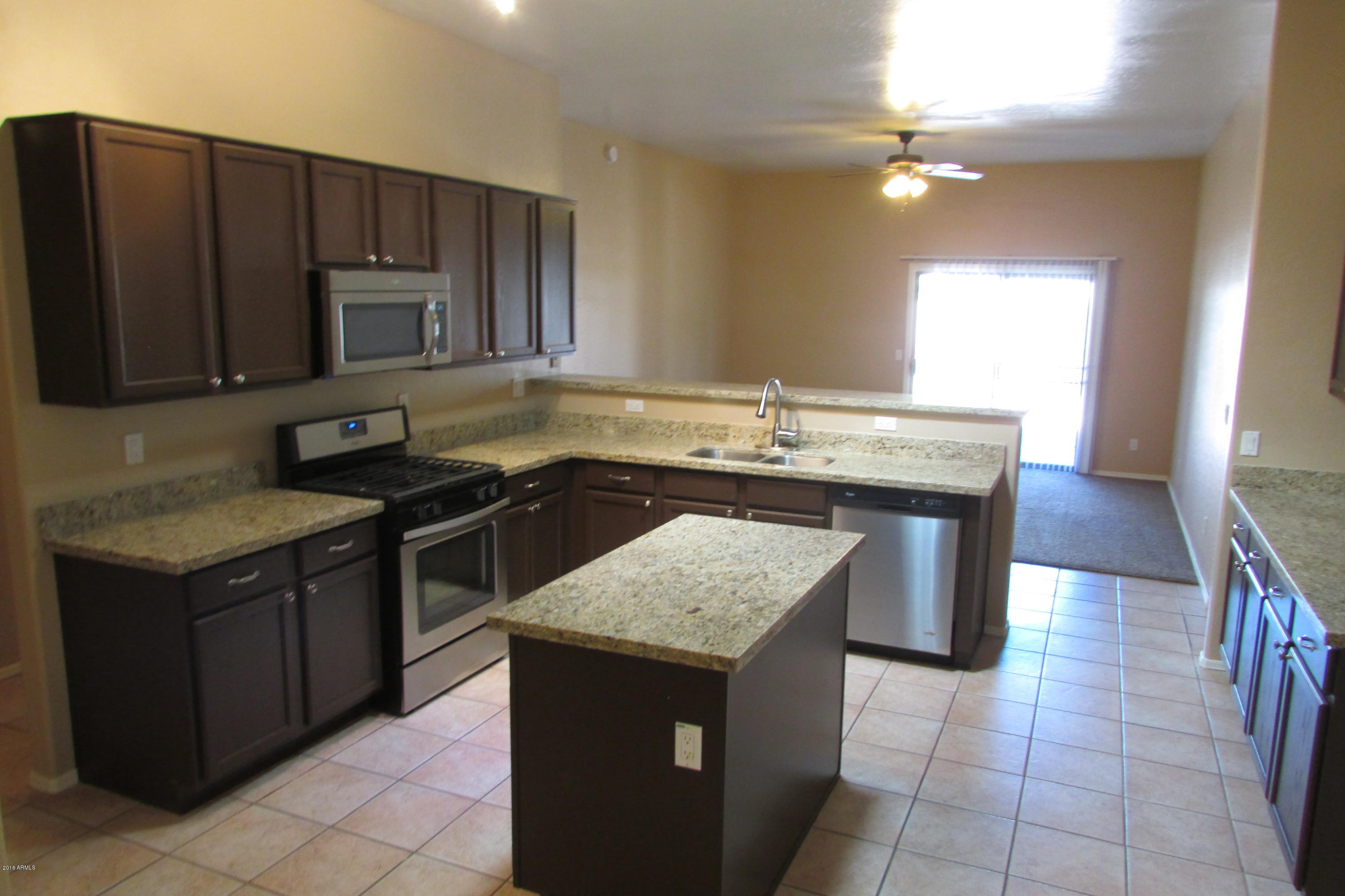 716 East Ranch Road Gilbert, AZ 85296 - Photo 6 of 22 a kitchen with a stove a sink a microwave a counter top space and cabinets