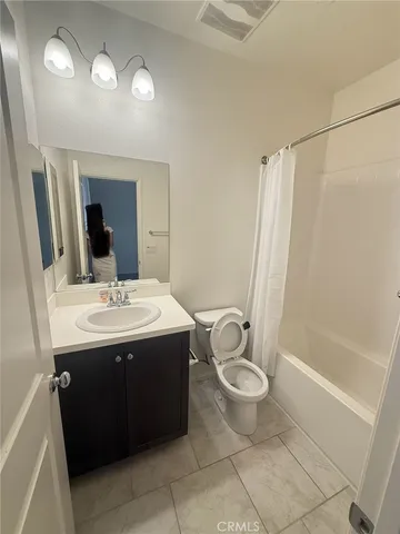 a bathroom with a sink mirror vanity and toilet