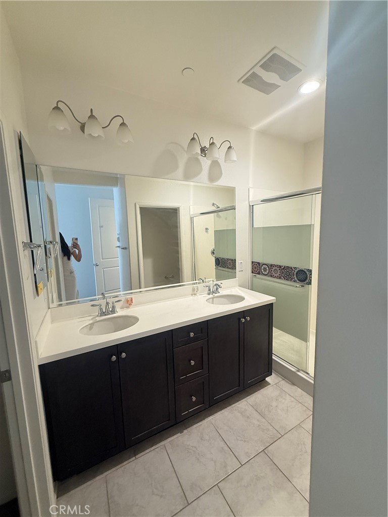 7400 Solstice Place Rancho Cucamonga, CA 91739 - Photo 16 of 22 a spacious bathroom with a double vanity sink and mirror
