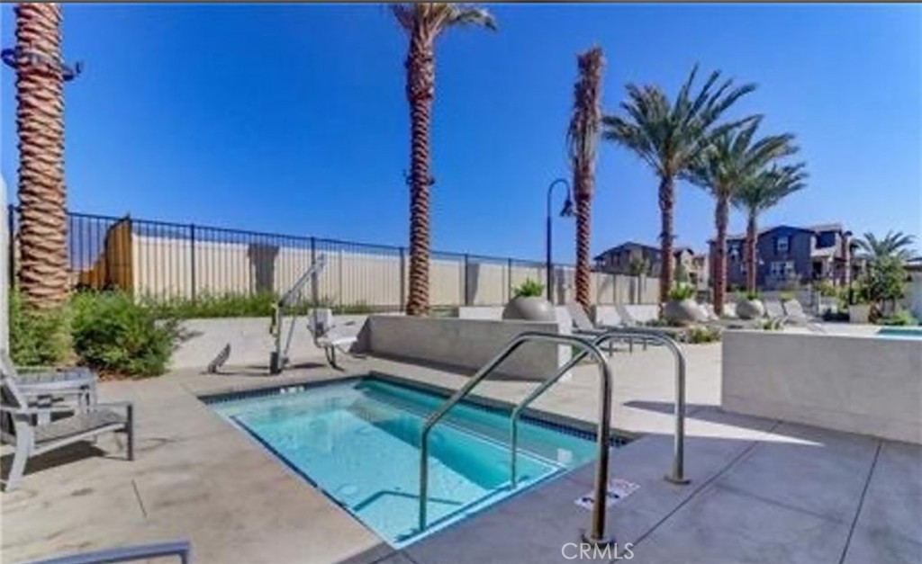 7400 Solstice Place Rancho Cucamonga, CA 91739 - Photo 18 of 22 a view of a patio with couches and chairs under an umbrella with potted plants