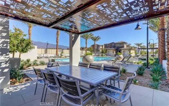 a view of a patio with a table and chairs and potted plants