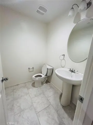 a bathroom with a sink toilet and mirror