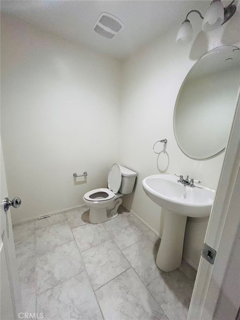 7400 Solstice Place Rancho Cucamonga, CA 91739 - Photo 8 of 22 a bathroom with a sink toilet and mirror
