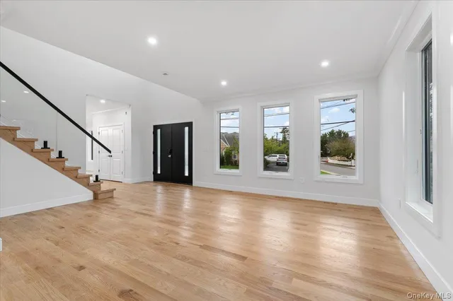 a view of an entryway with wooden floor and door