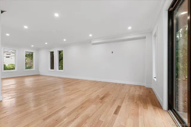 a view of kitchen with kitchen island wooden floor center island and stainless steel appliances