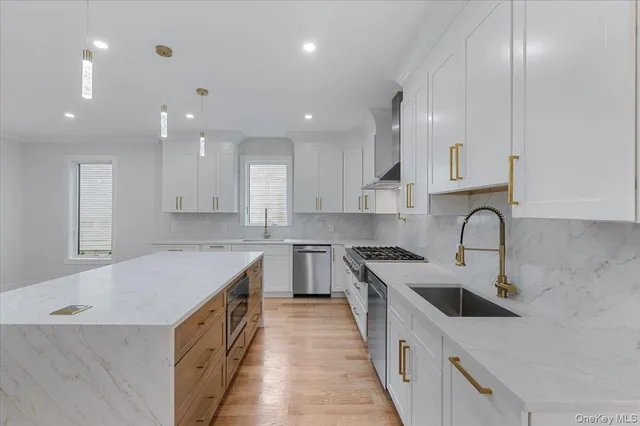 a large kitchen with stainless steel appliances granite countertop a stove a sink dishwasher and a refrigerator