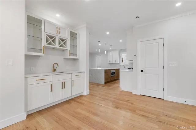 a view of a kitchen with sink and wooden floor