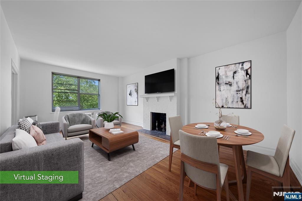 a living room with furniture a fireplace and a large window