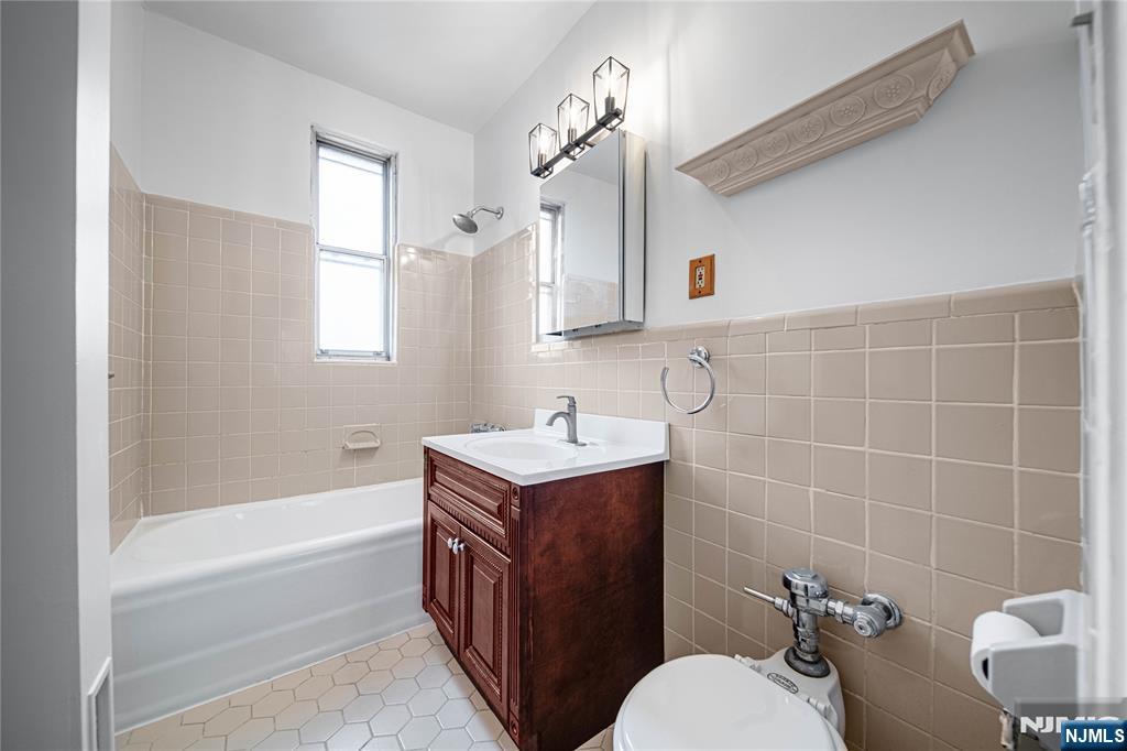 100 East Palisade Avenue, Unit B51 Englewood, NJ 07631 - Photo 14 of 37 a bathroom with a sink a toilet and shower