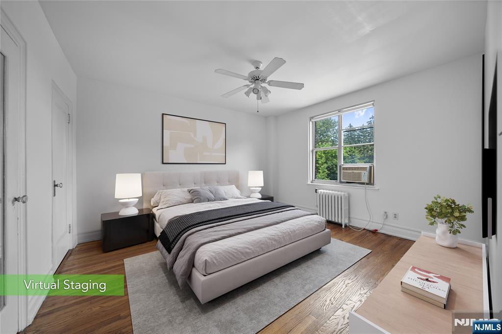 100 East Palisade Avenue, Unit B51 Englewood, NJ 07631 - Photo 15 of 37 a spacious bedroom with a bed lamp and a potted plant