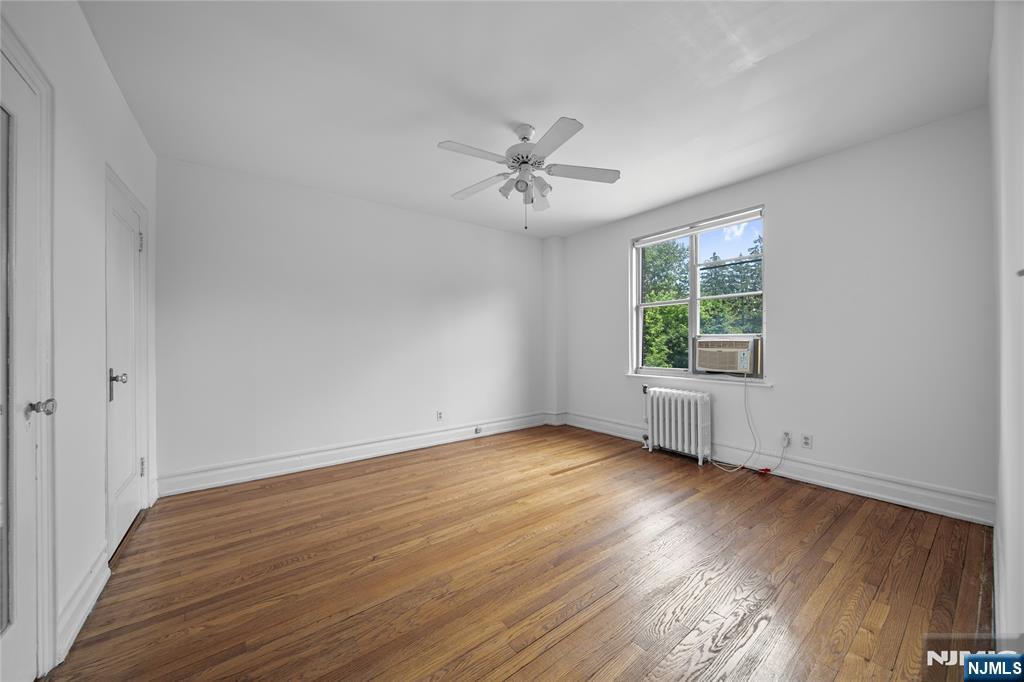 100 East Palisade Avenue, Unit B51 Englewood, NJ 07631 - Photo 16 of 37 an empty room with wooden floor ceiling fan and windows