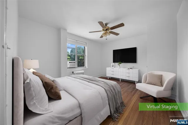 a bedroom with a bed television window and a flat screen tv