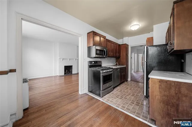 a kitchen with stainless steel appliances granite countertop a refrigerator stove and oven