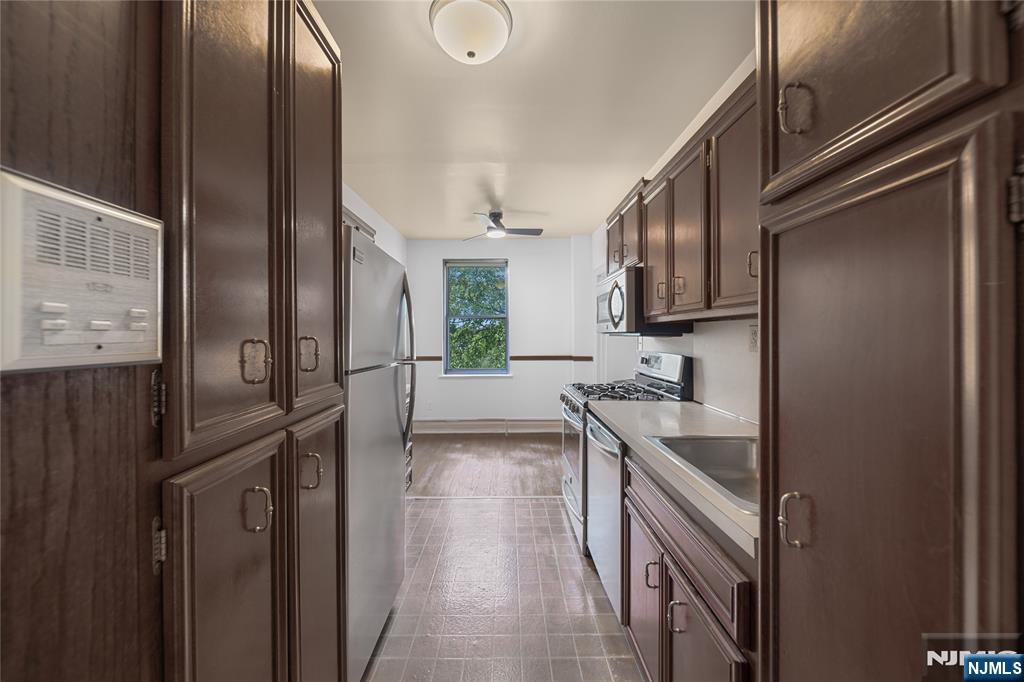 100 East Palisade Avenue, Unit B51 Englewood, NJ 07631 - Photo 10 of 37 a kitchen with stainless steel appliances granite countertop a refrigerator and a sink