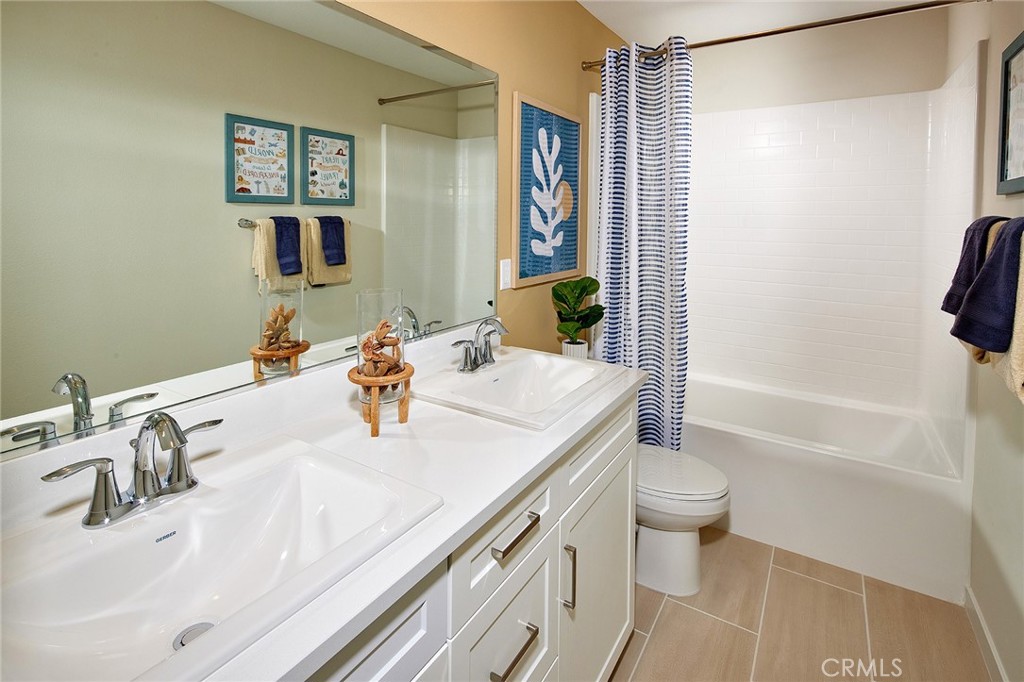 30952 Campania Road Highland, CA 92346 - Photo 16 of 27 a bathroom with a sink a toilet and shower