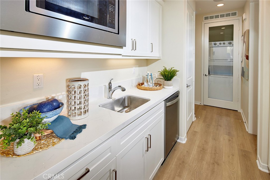 30952 Campania Road Highland, CA 92346 - Photo 20 of 27 a kitchen with stainless steel appliances lots of counter space and wooden floor