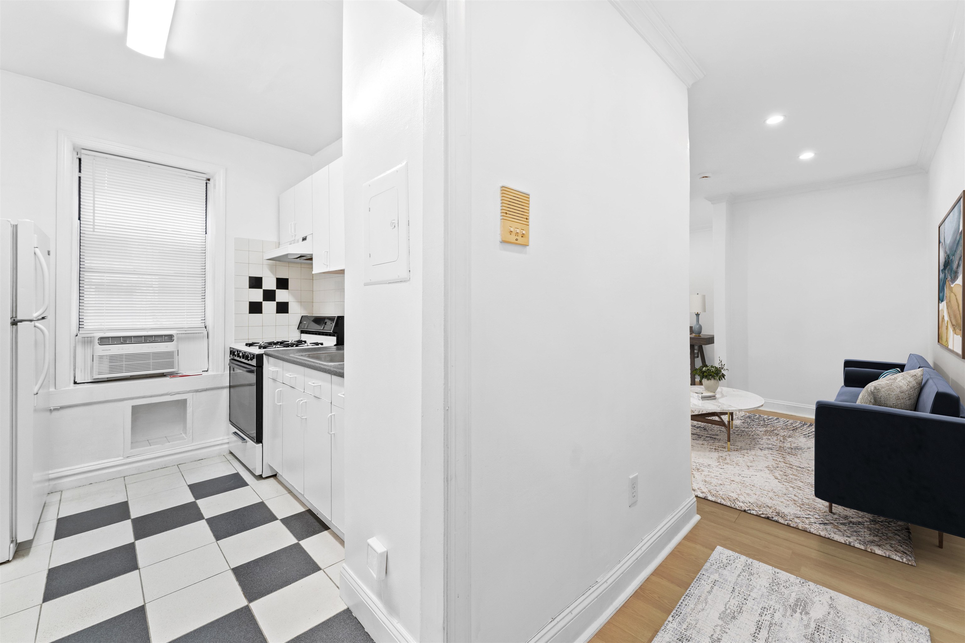 35-39 51st Street, Unit A4 Weehawken, NJ 07086 - Photo 3 of 16 a kitchen with a refrigerator and white cabinets