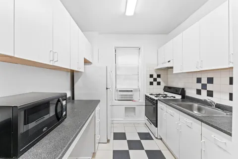 a kitchen with stainless steel appliances a stove a sink and a refrigerator