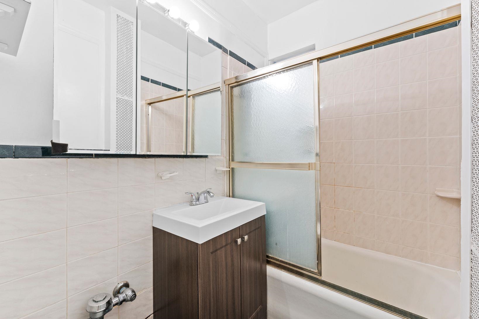 35-39 51st Street, Unit A4 Weehawken, NJ 07086 - Photo 10 of 16 a bathroom with a sink and mirror
