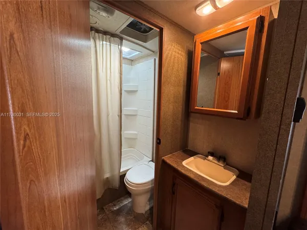 a bathroom with a toilet a sink and shower