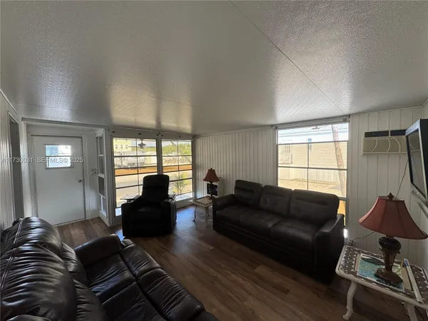a living room with furniture window and wooden floor