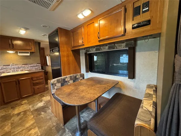 a kitchen with stainless steel appliances kitchen island granite countertop wooden cabinets and granite counter tops