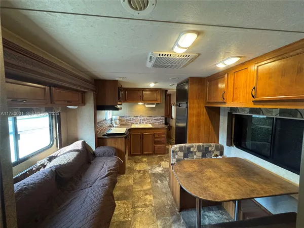 a large kitchen with a table and chairs