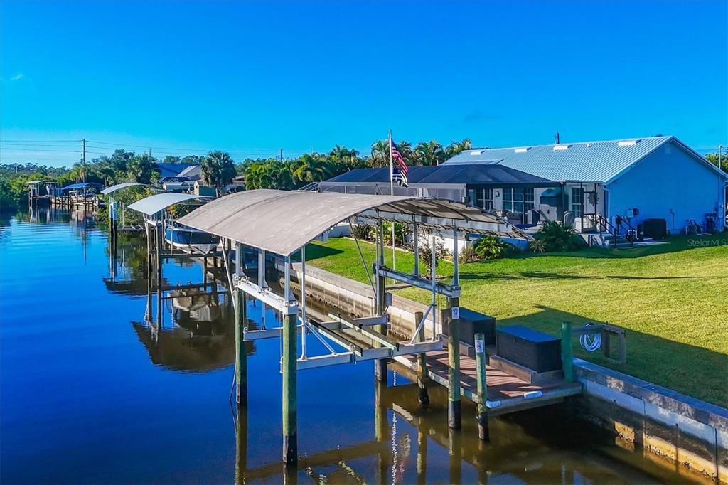 5276 Early Terrace Port Charlotte, FL 33981 - Photo 2 of 20 a aerial view of a house with swimming pool patio and outdoor seating
