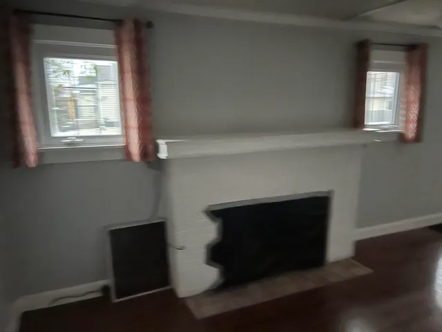 a living room with a fireplace and a window