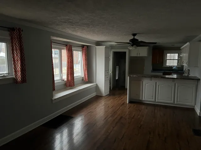 wooden floor in an empty room with a window
