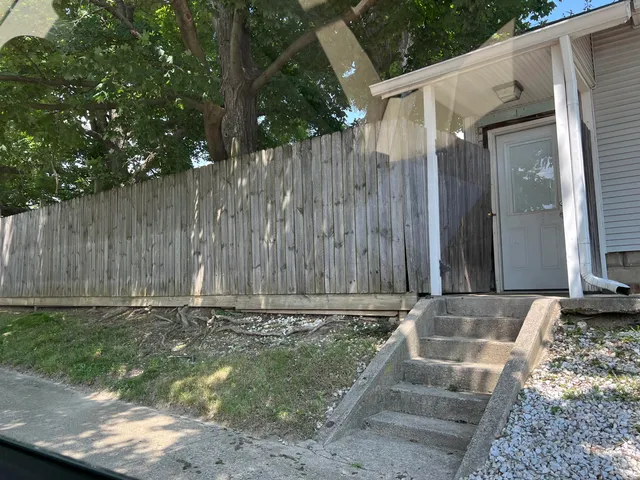 a view of outdoor space with wooden fence