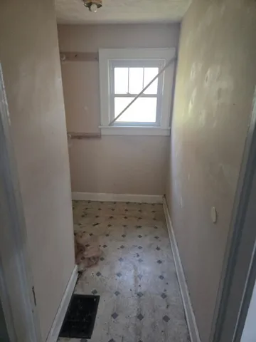 an empty room with a empty space and a window