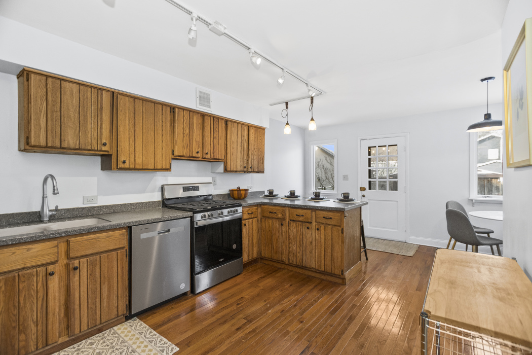 Undisclosed Address Evanston, IL 60201 - Photo 14 of 39 a kitchen with stainless steel appliances granite countertop wooden cabinets a sink dishwasher a stove and a refrigerator with wooden floor