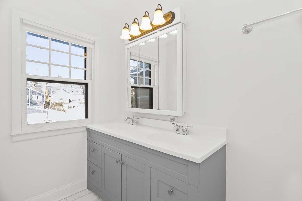 Undisclosed Address Evanston, IL 60201 - Photo 28 of 39 a bathroom with a sink mirror and a window