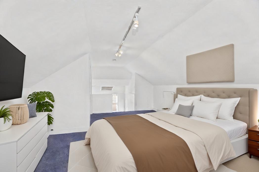 Undisclosed Address Evanston, IL 60201 - Photo 29 of 39 a bedroom with a large bed and a potted plant