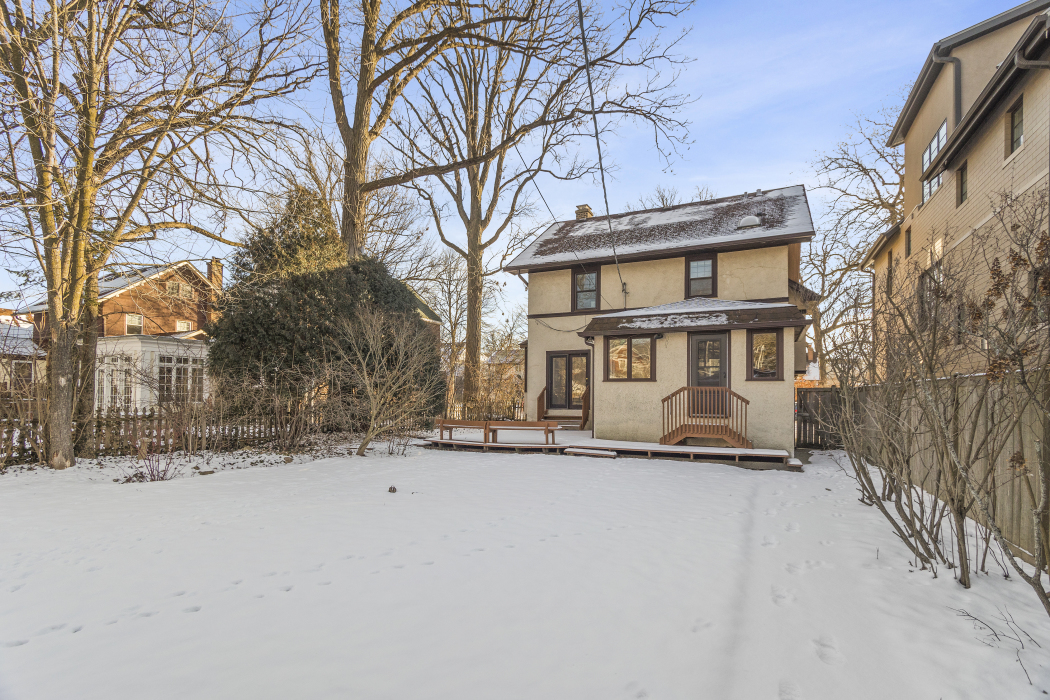 Undisclosed Address Evanston, IL 60201 - Photo 32 of 39 a front view of a house with a yard covered in snow