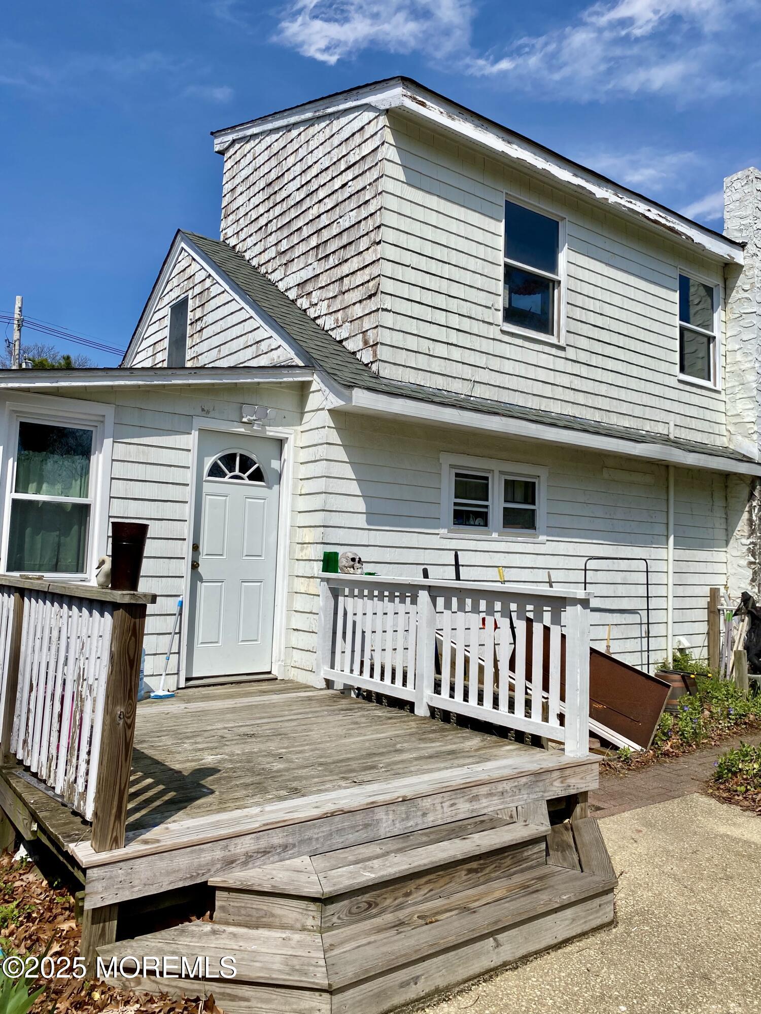 a view of a house with wooden deck