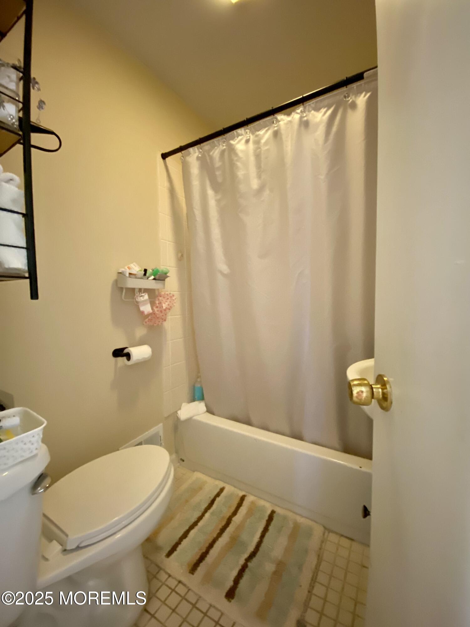 439 Mantoloking Road Brick, NJ 08723 - Photo 14 of 19 a bathroom with a toilet and a shower curtain