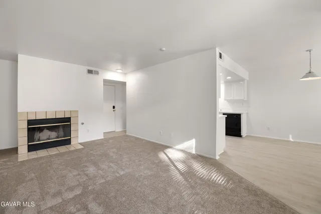 a view of empty room with a fireplace