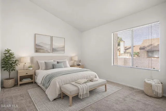 a bedroom with a bed and a painting on the wall